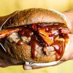 person holding grilled cheese burger